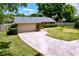Well-maintained home with a two-car garage, stone accents, manicured lawn, and a paved driveway at 4601 Autumnwind Ct, Tampa, FL 33624