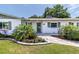 Charming single-story home with a walkway to the door and lovely landscaping at 5101 Vinson Dr, Tampa, FL 33610