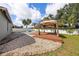 Backyard with pool, gazebo, patio area and tasteful landscaping at 5189 Brackenwood Dr, Spring Hill, FL 34609