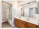 Bathroom with double sink vanity and shower over tub at 5189 Brackenwood Dr, Spring Hill, FL 34609