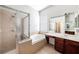 Bathroom featuring a glass shower, soaking tub, vanity, and tile flooring at 5189 Brackenwood Dr, Spring Hill, FL 34609