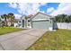 Single-story home with a long driveway and attached two-car garage at 5189 Brackenwood Dr, Spring Hill, FL 34609
