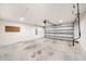 Spacious two car garage with high ceilings and an automatic garage door at 5189 Brackenwood Dr, Spring Hill, FL 34609
