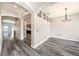 Arched doorway and gray wood floors connect spaces in this open floor plan at 5189 Brackenwood Dr, Spring Hill, FL 34609