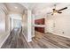 Hallway with gray floors and views into the living room and kitchen at 5189 Brackenwood Dr, Spring Hill, FL 34609