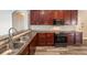 Kitchen with granite countertops, stainless sink and appliances, and tile backsplash at 5189 Brackenwood Dr, Spring Hill, FL 34609