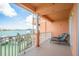 Spacious balcony with outdoor lounge chairs overlooking the waterfront, offering relaxing views at 530 S Gulfview Blvd # 303, Clearwater, FL 33767