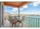 Outdoor seating area on the balcony with waterfront views and an outdoor table with seating at 530 S Gulfview Blvd # 303, Clearwater, FL 33767