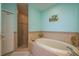 Well-lit bathroom with a soaking tub, a separate tiled shower, and toilet at 530 S Gulfview Blvd # 303, Clearwater, FL 33767