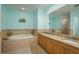 Large bathroom with dual sinks, granite countertops, a soaking tub, and a tiled shower at 530 S Gulfview Blvd # 303, Clearwater, FL 33767