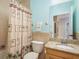 Bathroom with a shower-tub, decorated with a palm tree theme and a granite topped vanity at 530 S Gulfview Blvd # 303, Clearwater, FL 33767