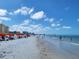 Beach view of condo building with people enjoying a beautiful sunny day at 530 S Gulfview Blvd # 303, Clearwater, FL 33767