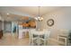 Open dining area with stylish chandelier, table seating, and seamless flow to the adjacent kitchen at 530 S Gulfview Blvd # 303, Clearwater, FL 33767