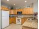 Kitchen features plenty of cabinet space, granite counters and modern appliances with tiled flooring at 530 S Gulfview Blvd # 303, Clearwater, FL 33767