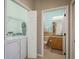 Convenient laundry room with washer, dryer, and storage shelving, located close to the bathroom at 530 S Gulfview Blvd # 303, Clearwater, FL 33767