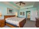 Spacious main bedroom features light blue walls, a ceiling fan, and an attached bathroom at 530 S Gulfview Blvd # 303, Clearwater, FL 33767