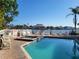 Community pool with lounge chairs and views of the bay at 530 S Gulfview Blvd # 303, Clearwater, FL 33767