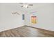Spacious bedroom with hardwood floors, a ceiling fan, and a window offering natural light at 5400 9Th N Ave, St Petersburg, FL 33710
