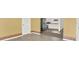 Open layout with kitchen view, stainless steel fridge, and wood-look flooring at 5400 9Th N Ave, St Petersburg, FL 33710