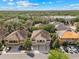 Aerial view of townhomes featuring well-maintained landscaping, private driveways, and a tranquil neighborhood at 5717 Kingletsound Pl, Lithia, FL 33547