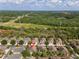 Community aerial view showing proximity to wooded areas, residential streets, and power lines at 5717 Kingletsound Pl, Lithia, FL 33547