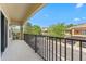 Relaxing balcony view overlooking a quaint neighborhood street and manicured landscaping at 5717 Kingletsound Pl, Lithia, FL 33547