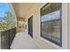 Comfortable balcony with black metal railing and ample natural light through sliding glass door at 5717 Kingletsound Pl, Lithia, FL 33547