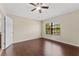 Light and airy bedroom with hardwood floors, ceiling fan, and window with blinds at 5717 Kingletsound Pl, Lithia, FL 33547