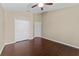 Bedroom featuring hardwood floors, ceiling fan, and closet for storage at 5717 Kingletsound Pl, Lithia, FL 33547