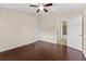 Spacious bedroom features hardwood floors, ceiling fan and ensuite bathroom at 5717 Kingletsound Pl, Lithia, FL 33547