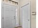 A bright entryway with white trim and tile floor at 5717 Kingletsound Pl, Lithia, FL 33547