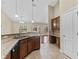 Open kitchen with granite counters, stainless steel dishwasher, and a view into the living room at 5717 Kingletsound Pl, Lithia, FL 33547