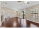 Bright living room with hardwood floors, neutral walls, and access to the patio via sliding glass doors at 5717 Kingletsound Pl, Lithia, FL 33547