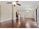 Open living room area with hardwood floors, neutral walls, and a ceiling fan to keep cool at 5717 Kingletsound Pl, Lithia, FL 33547