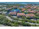 Wide aerial view highlights the community's lakefront location, landscaping, and convenient amenities at 6 Academy S Way # 23A, St Petersburg, FL 33711