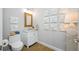 Half bathroom featuring marble countertops, tile flooring, and decorative wall art at 6 Academy S Way # 23A, St Petersburg, FL 33711