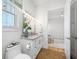 Bright bathroom featuring a white vanity with marble countertop and decorative lighting at 6 Academy S Way # 23A, St Petersburg, FL 33711