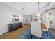Open dining room with chandelier, bright natural light, and a view into the living area at 6 Academy S Way # 23A, St Petersburg, FL 33711