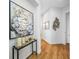 Bright hallway featuring hardwood floors and a decorative flower arrangement at 6 Academy S Way # 23A, St Petersburg, FL 33711