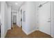 Hallway with tiled floors leading to various rooms, showcasing neutral wall colors and clean lines at 6 Academy S Way # 23A, St Petersburg, FL 33711