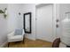 Bright hallway featuring a mirror, accent lighting, and a comfortable chair with pillow at 6 Academy S Way # 23A, St Petersburg, FL 33711