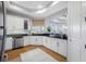 Bright kitchen with white cabinets, stainless steel appliances, and granite countertops, offering ample space and storage at 6 Academy S Way # 23A, St Petersburg, FL 33711