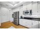 Bright kitchen with stainless steel appliances and white cabinets, offering a clean and modern design at 6 Academy S Way # 23A, St Petersburg, FL 33711