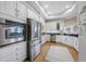 Bright kitchen features stainless steel appliances and ample white cabinets and counter space with a wine rack at 6 Academy S Way # 23A, St Petersburg, FL 33711
