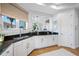 Bright kitchen with granite countertops, stainless steel appliances, and white cabinets, offering ample space and storage at 6 Academy S Way # 23A, St Petersburg, FL 33711