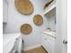 Functional laundry area featuring a sink, white cabinets, and decorative wall art at 6 Academy S Way # 23A, St Petersburg, FL 33711