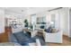 Bright living room featuring comfortable seating, tile floors, and view into other living spaces at 6 Academy S Way # 23A, St Petersburg, FL 33711