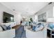 Spacious living room with tile floors, modern decor, and a view of the dining and kitchen area at 6 Academy S Way # 23A, St Petersburg, FL 33711