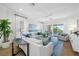 Comfortable living room with neutral furniture, tile floors, and sliding glass doors to the balcony at 6 Academy S Way # 23A, St Petersburg, FL 33711