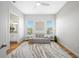 Relaxing living room with neutral tones, featuring a sofa, stylish rug, and natural light from two windows at 6 Academy S Way # 23A, St Petersburg, FL 33711